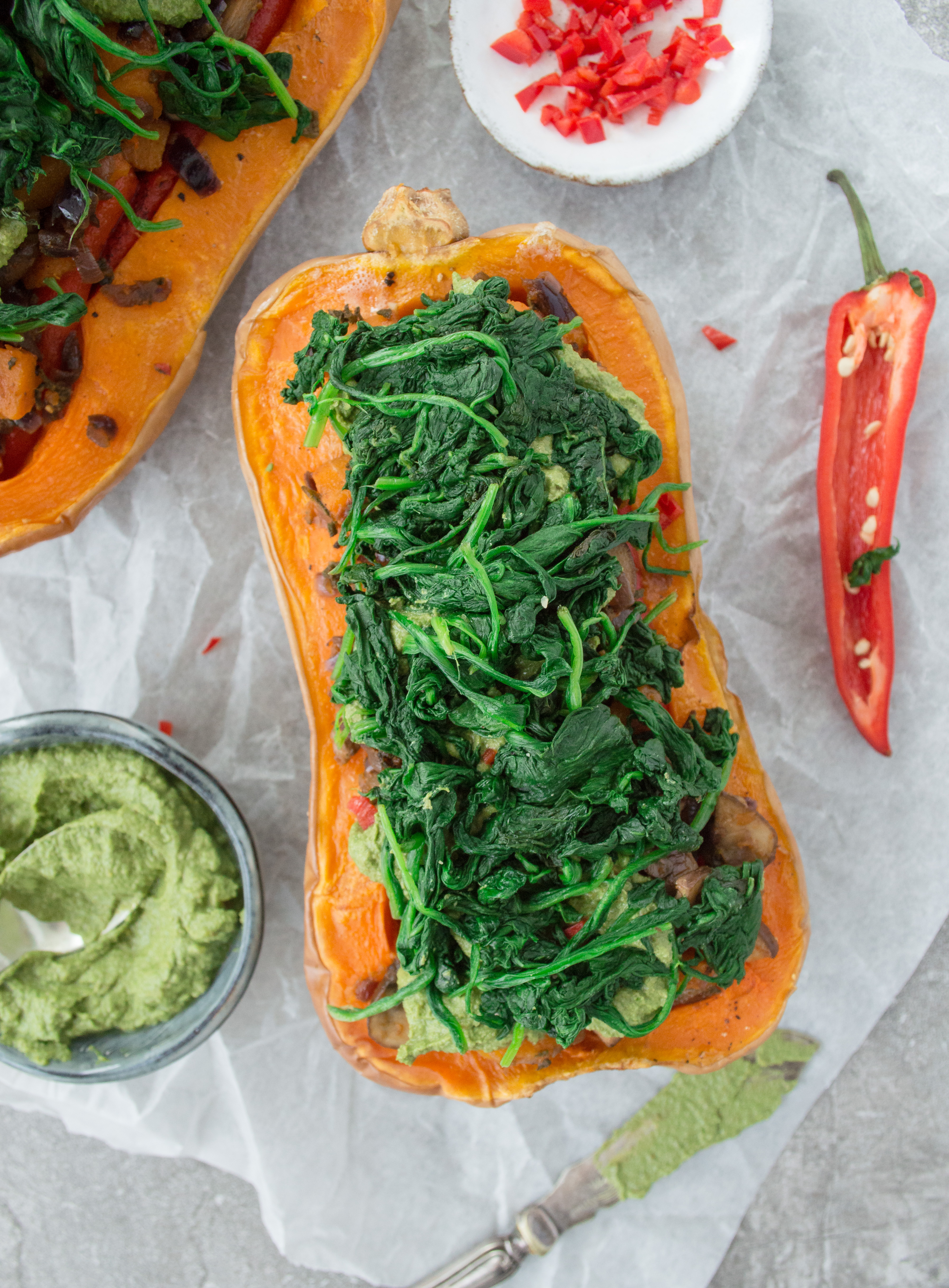 Butternut squash halves stuffed with spinach and vegetables