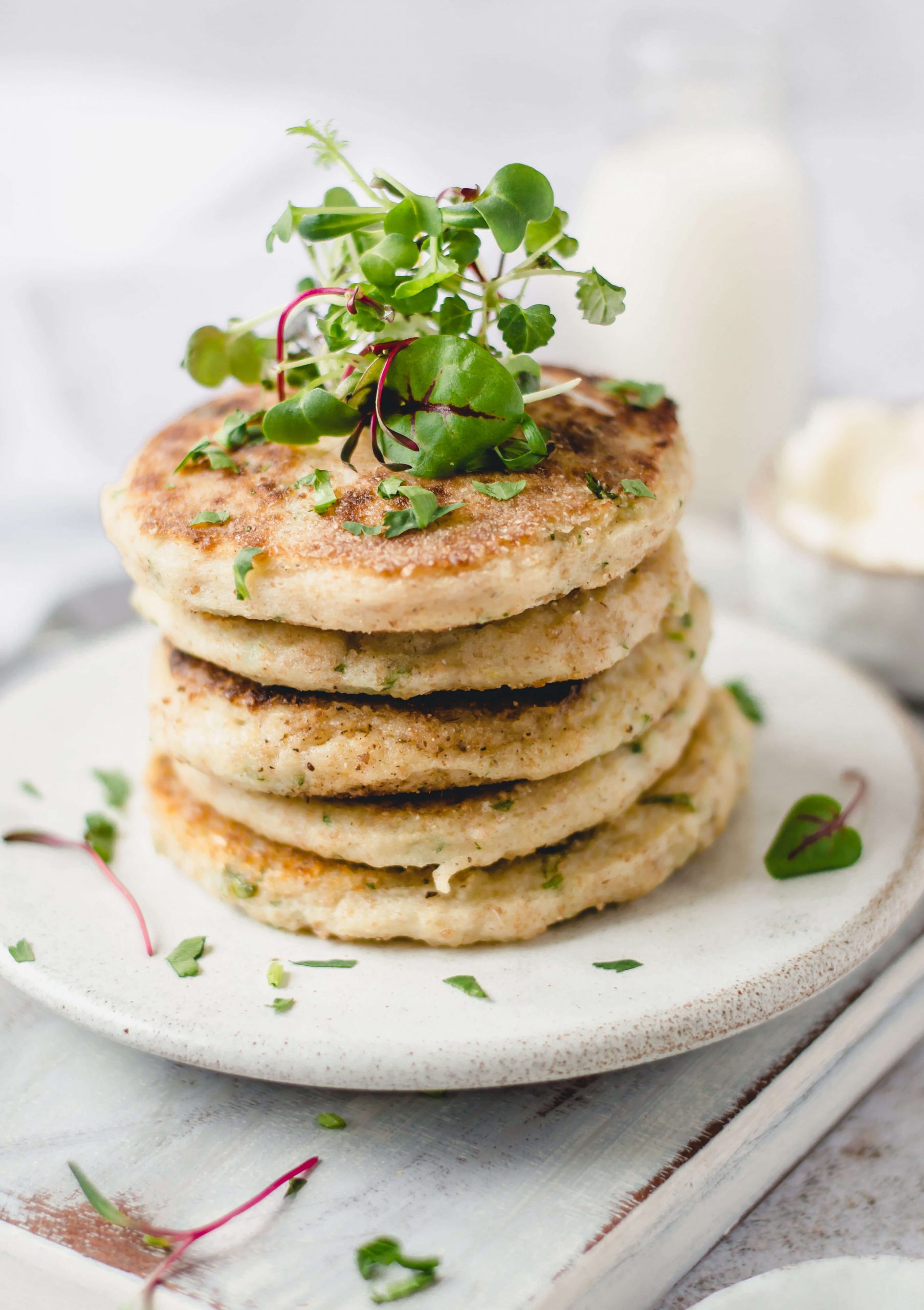 Vegan potato cakes stack garnished with herbs 