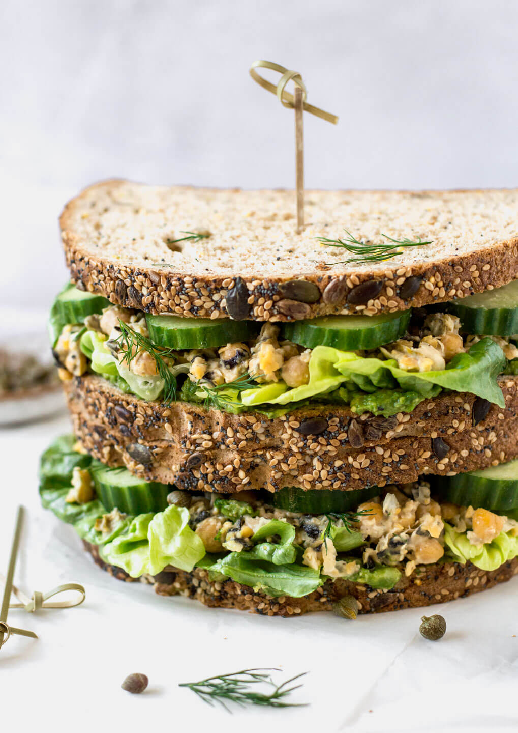 Straight on view of vegan tuna sandwich on a white board - Fit Foodie Nutter