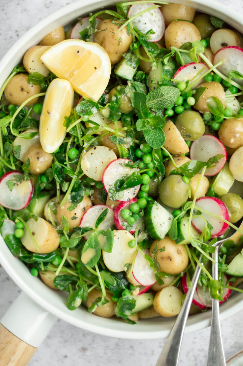 Vegan potato salad in a white bowl, close up view 