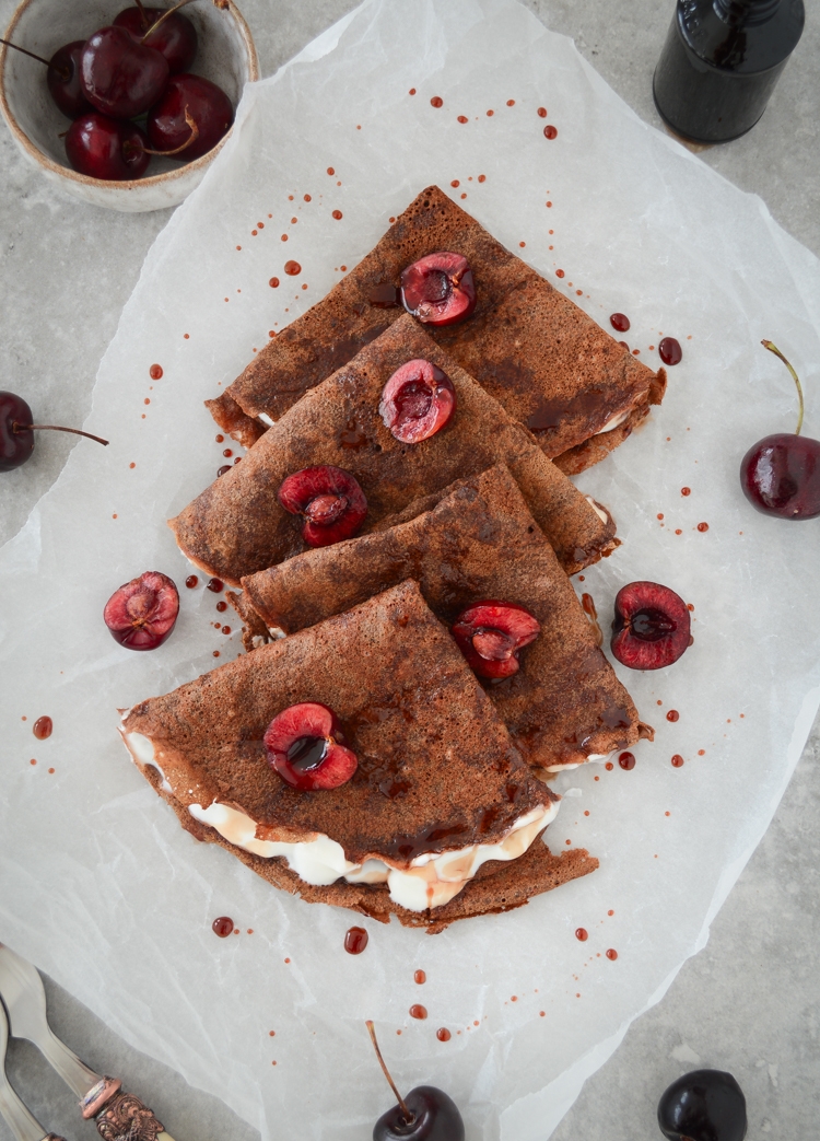 Chocolate crepes served with yoghurt and fresh cherries 