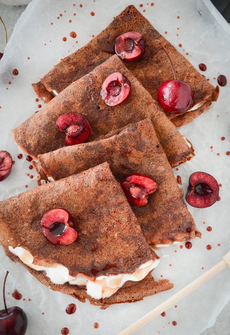 Chocolate protein crepes served with yoghurt and fresh cherries 