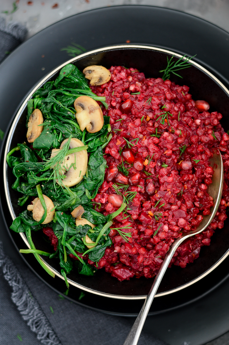 Beetroot & buckwheat risotto with mushrooms in a black bowl