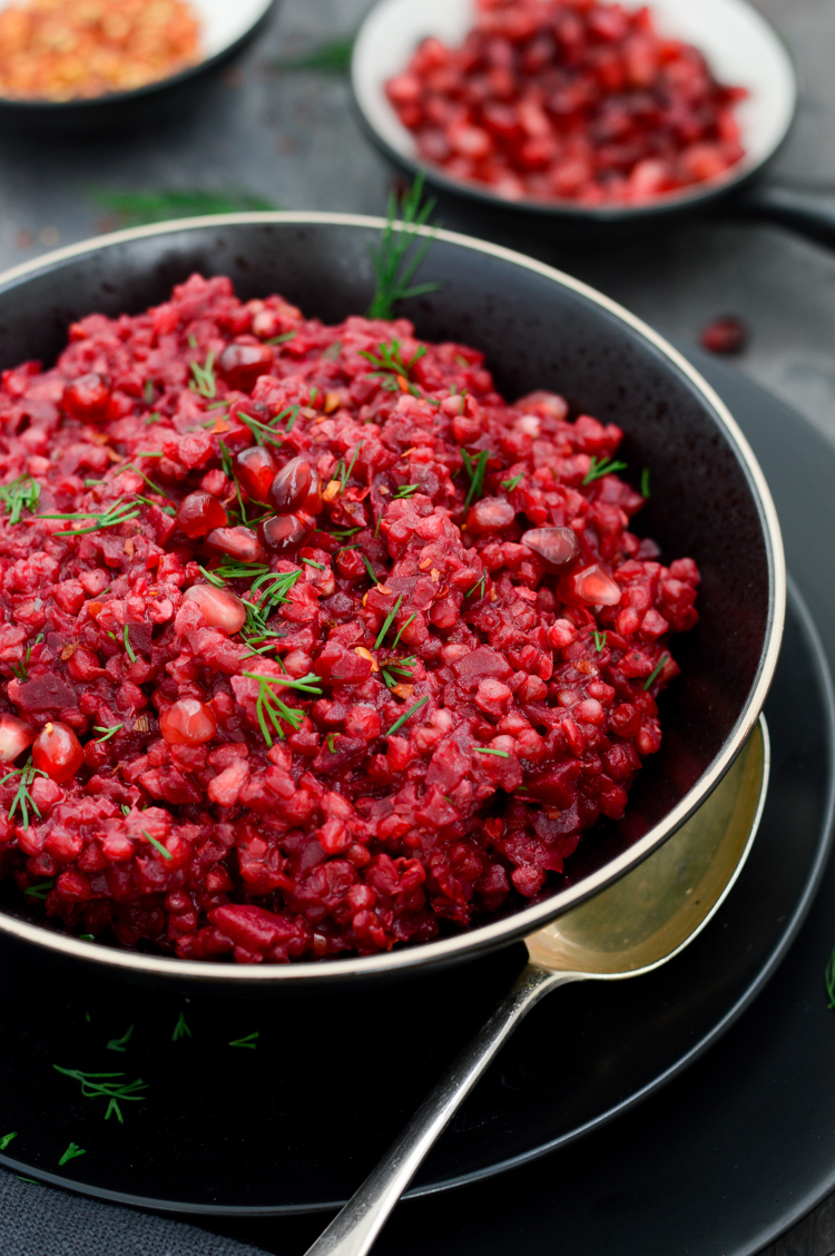 Beetroot & buckwheat risotto in a black bowl
