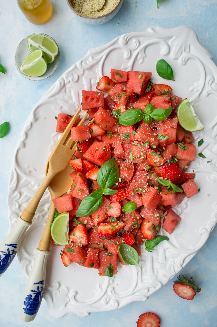 Watermelon salad with vegan Parmesan on a white plate