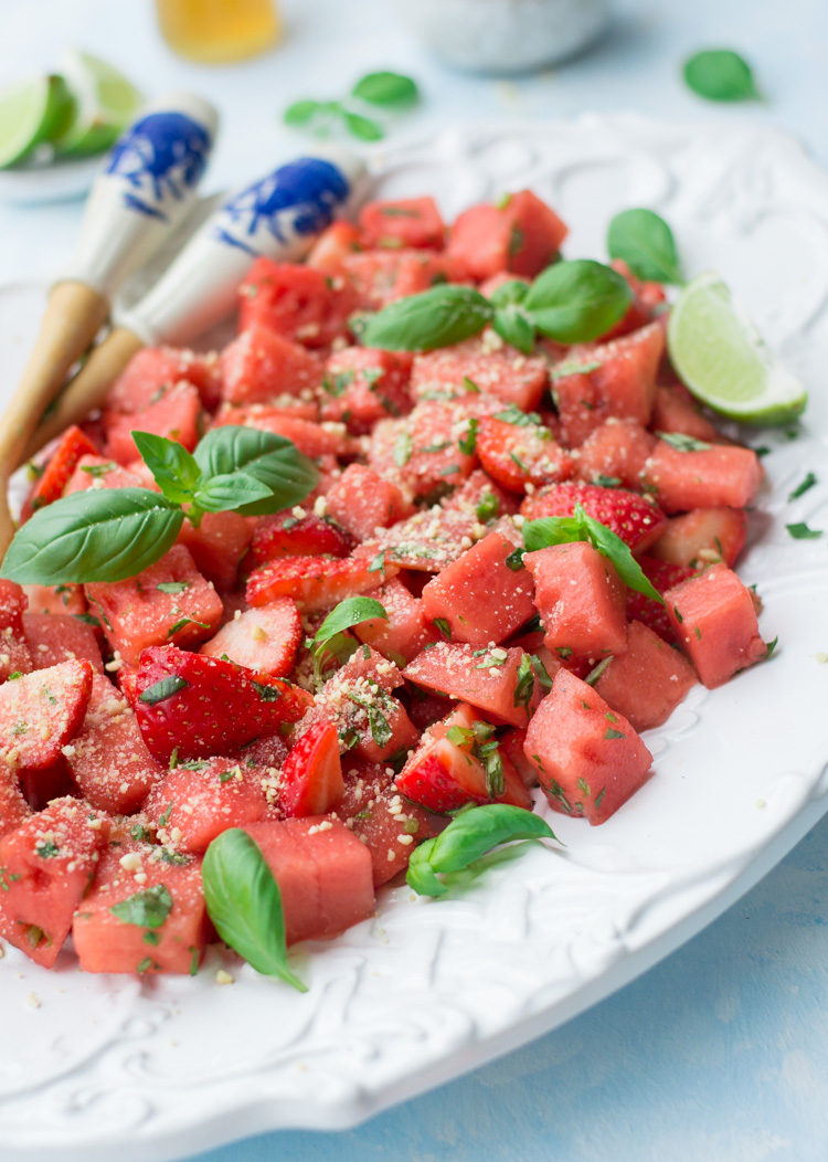 Close up of Watermelon salad with vegan Parmesan on a white plate 