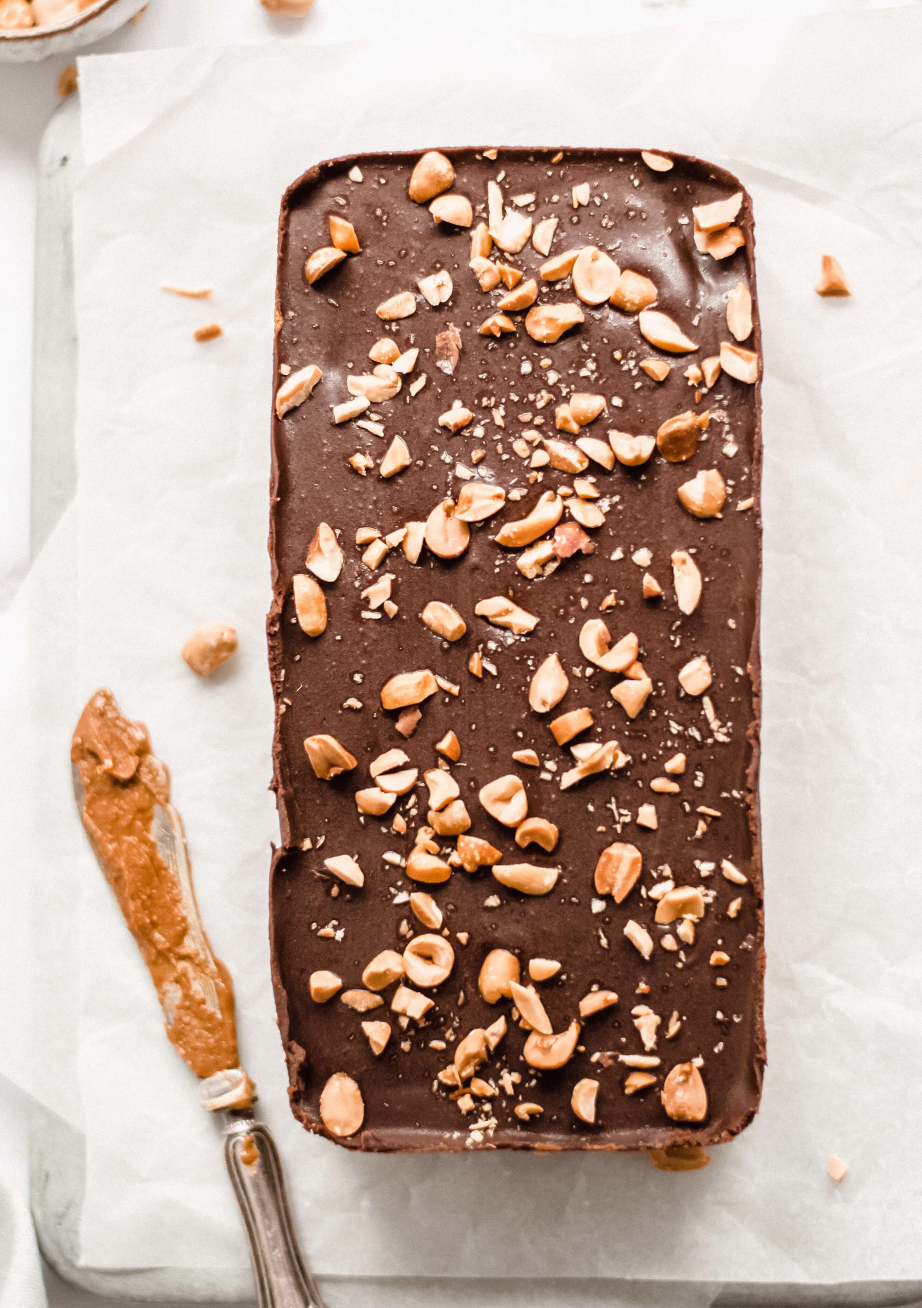 Top down view of vegan peanut and caramel bars loaf, knife on the side 