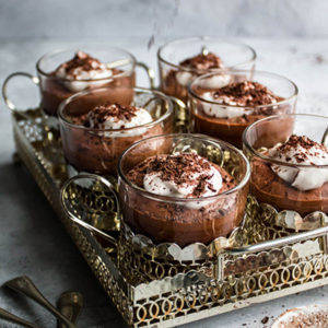 vegan chocolate mousse in small glasses in a silver tray