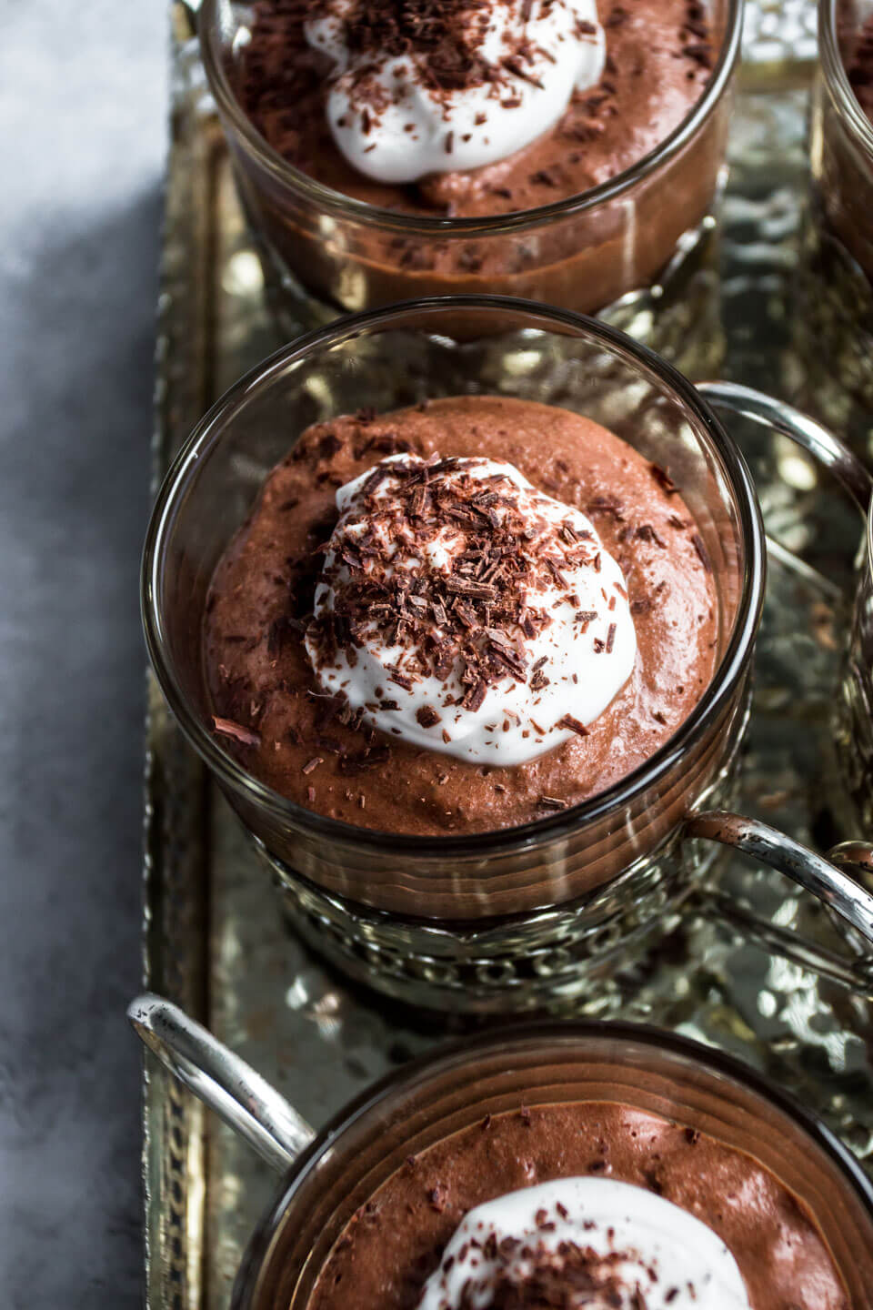 Close up of vegan chocolate mousse in small glasses in a silver tray 