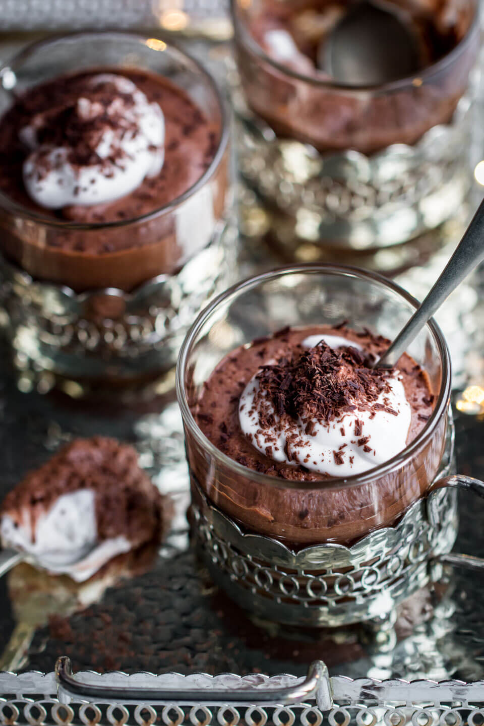 vegan chocolate mousse in small glasses in a silver tray 