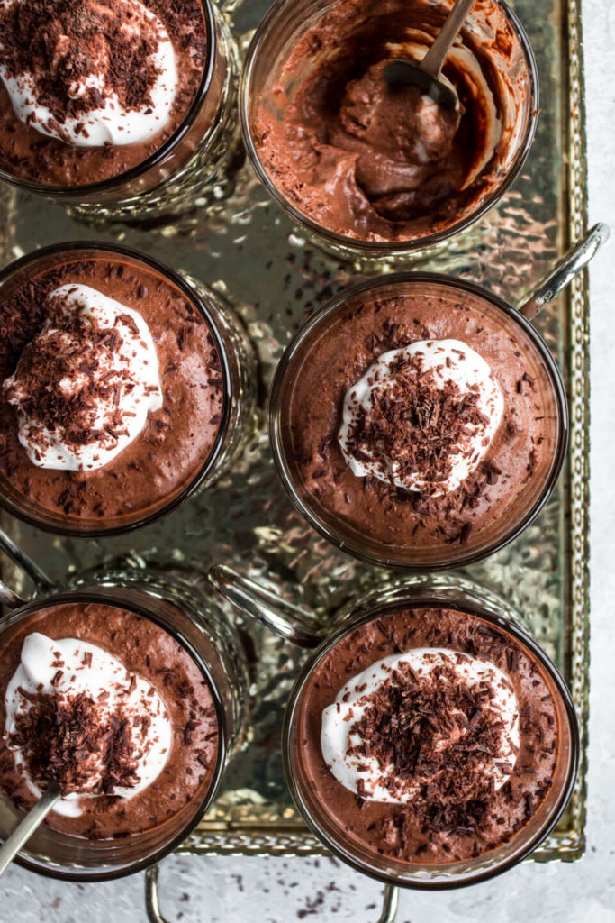 vegan chocolate mousse in small glasses on a silver tray 