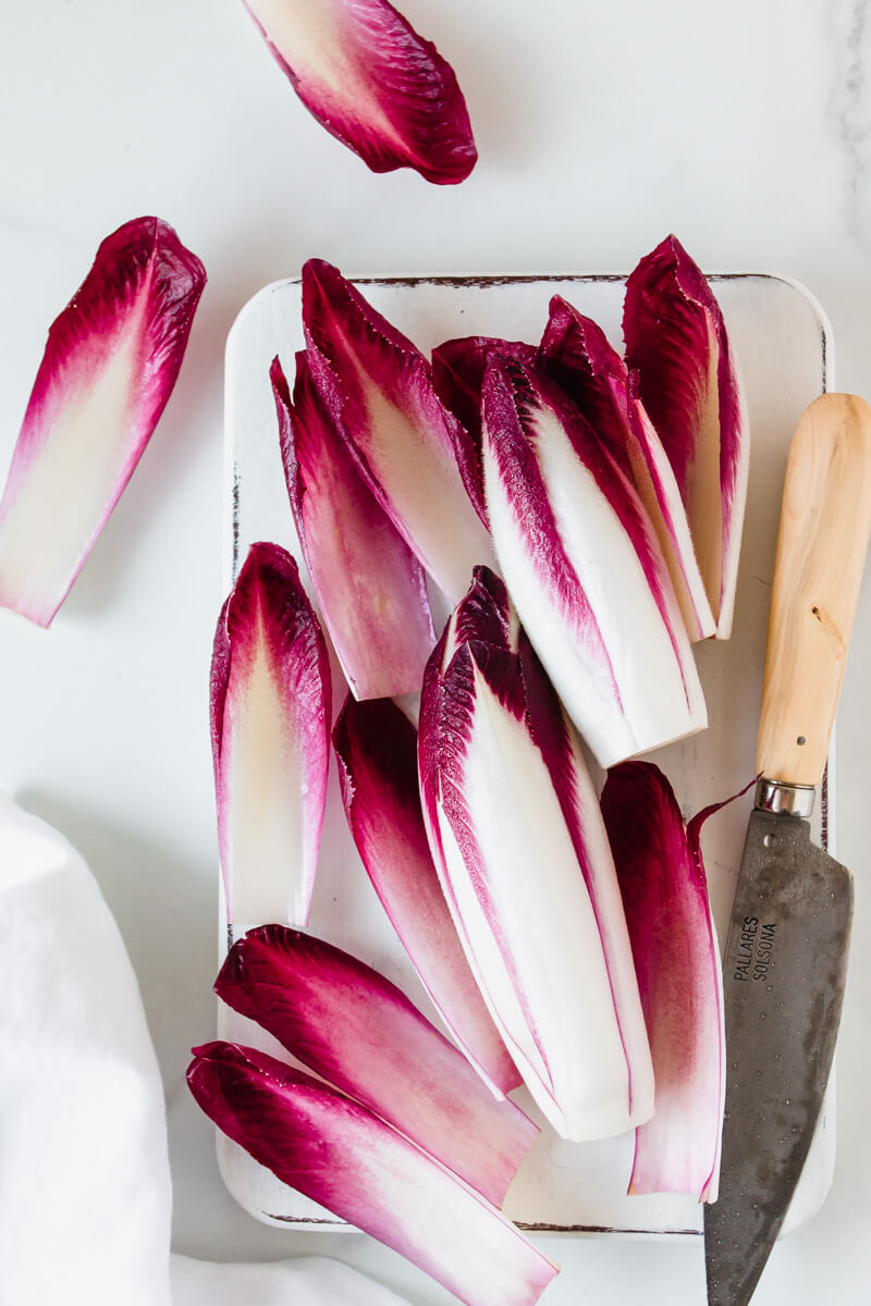 Top down view of red chicory leaves, knife on the side 