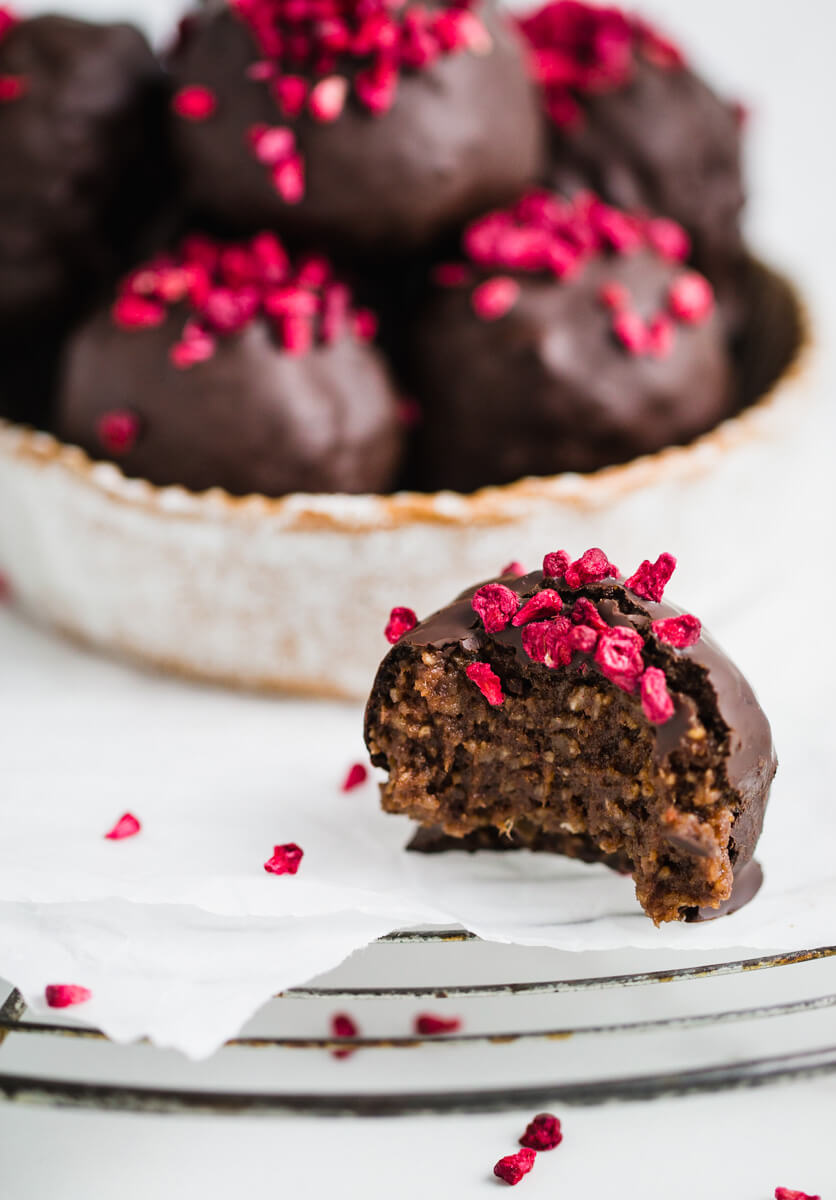 close up of chocolate date balls in a round dish 