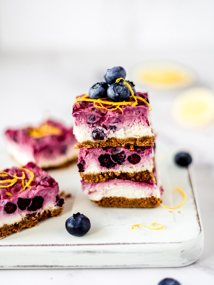 A stack of vegan blueberry lemon cheesecake bars
