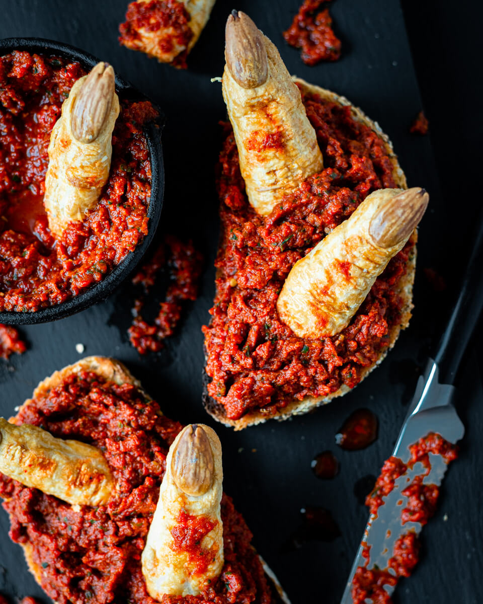 Spooky Halloween toast with bloody red pepper dip and witches' fingers