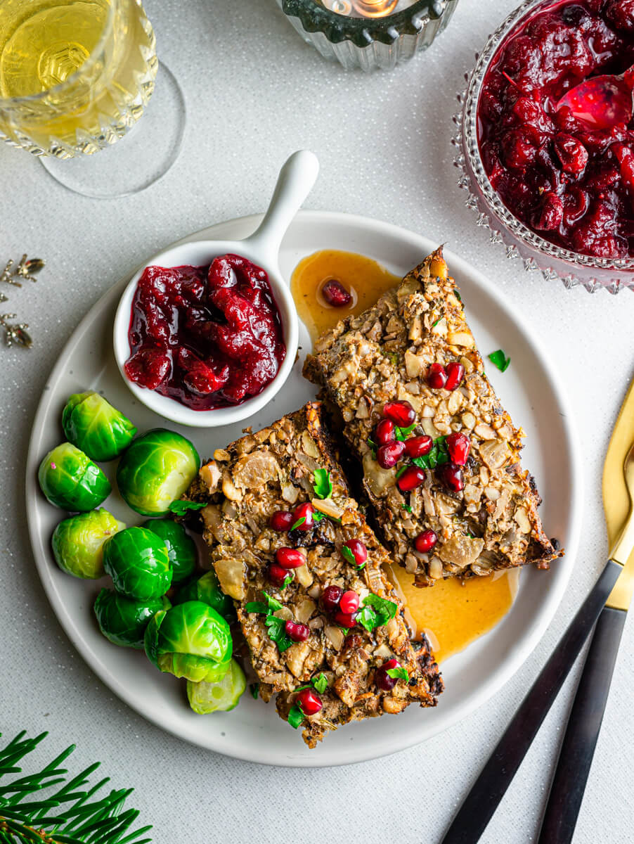 Overhead view of a plate with vegan nut roast, Brussel sprouts and cranberry sauce