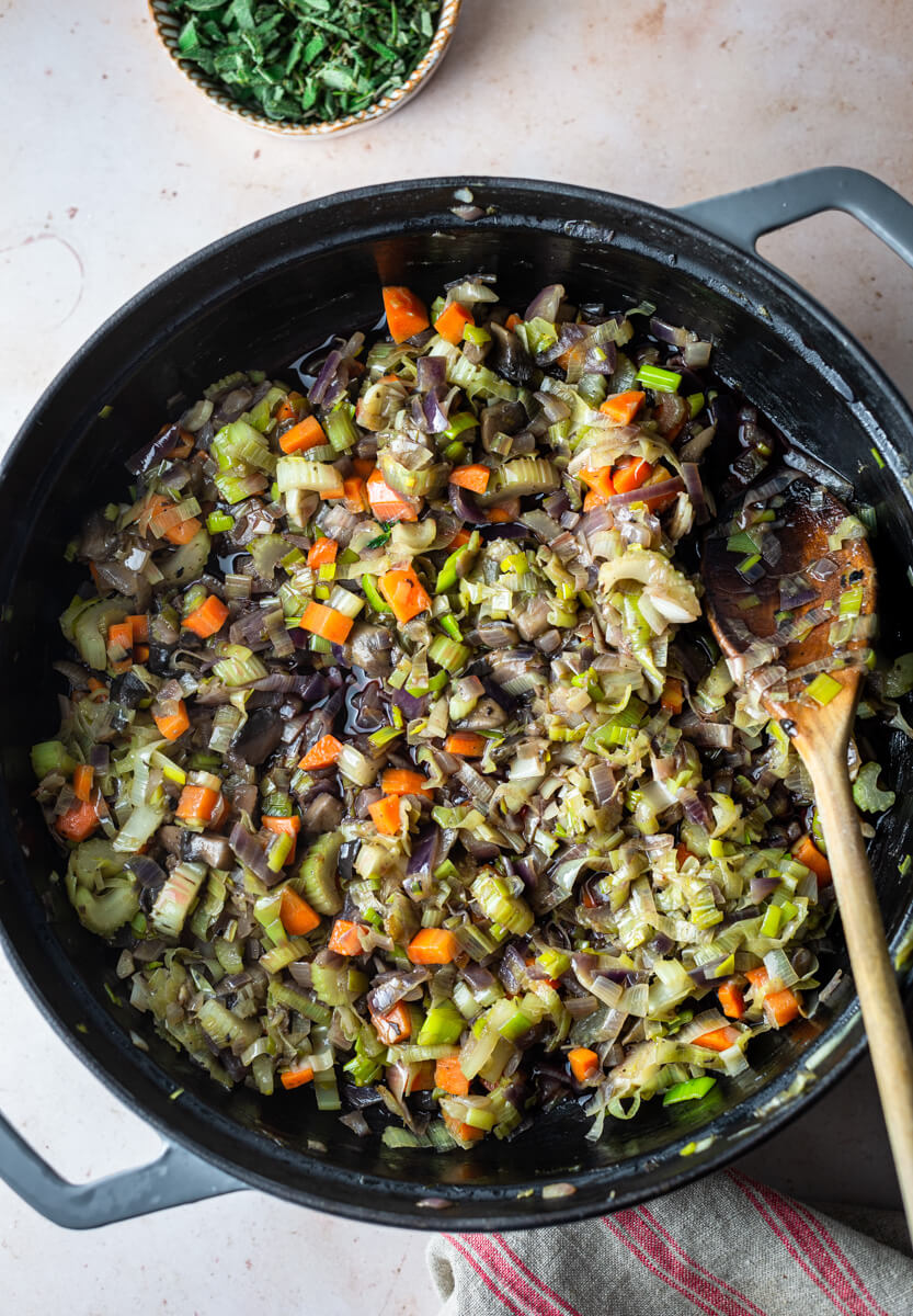 A pan with sauteed vegetables for making vegan nut roast